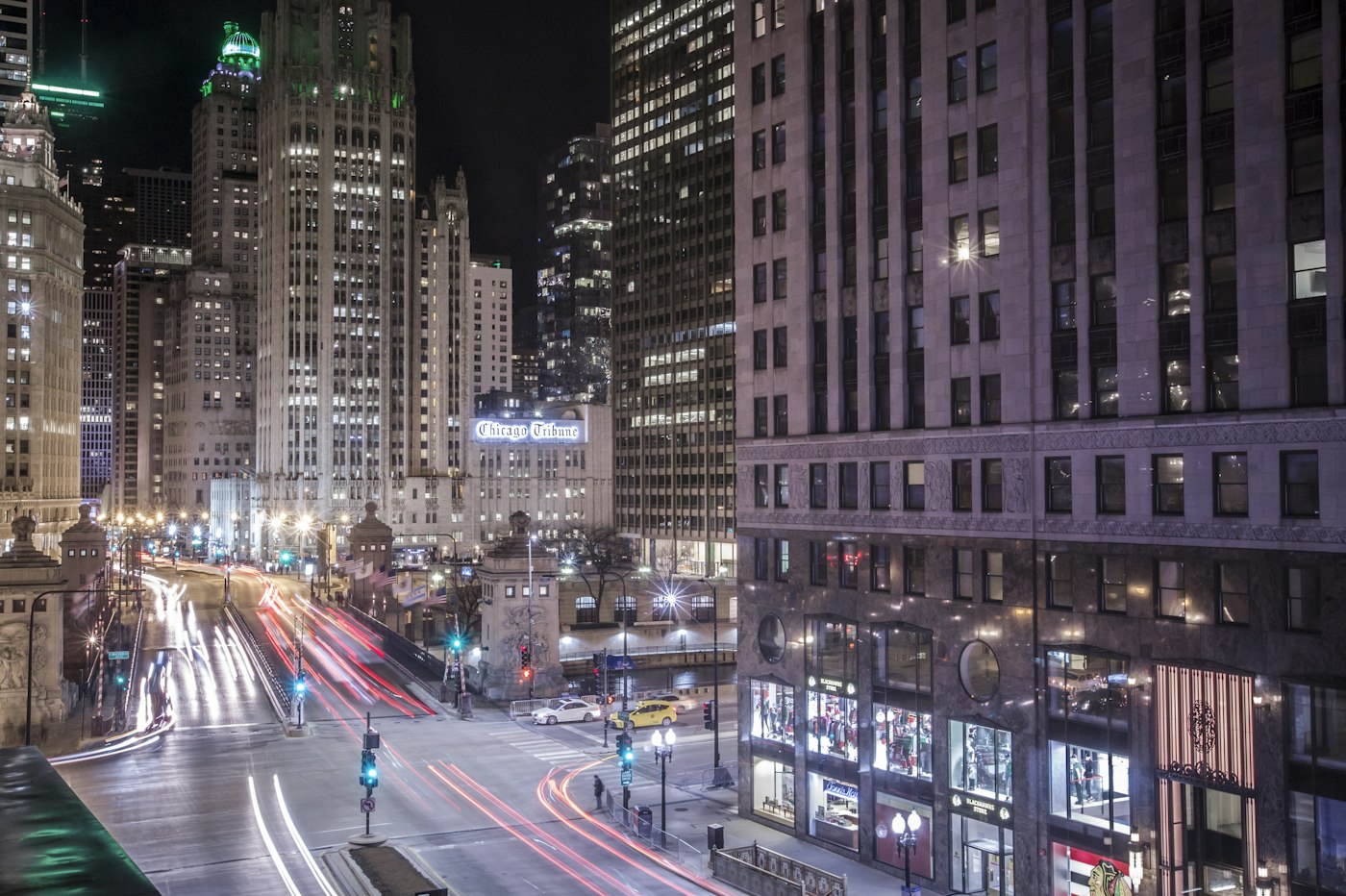 Night traffic on a downtown Chicago street by the Tribune building